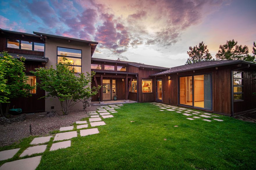 Tucked in the heart of Shevlin Commons, oriented for maximum privacy and snow-capped mountain views, this home was built to blend harmoniously with the natural land
that surrounds on nearly all sides. Here, guests are welcomed by a private front courtyard, calming water feature, and secluded sun-drenched patio. In the great room, a wall of windows offers incredible natural light, complimenting the modern style of the concrete hearth. An inspiring kitchen is complete with beverage fridge, custom cabinetry, GE Monogram SS appliances, and access to the covered patio for grilling. Enjoy main-level living with the primary suite and a mother-in-law suite with a private entrance on the first floor. Upstairs, find two additional bedrooms and loft space for reading or play. This exquisite home offers the best of Bend living, with endless special features such as: three car tandem garage, spacious mudroom, hidden sauna, fire pit, and outdoor living space with views from every angle.