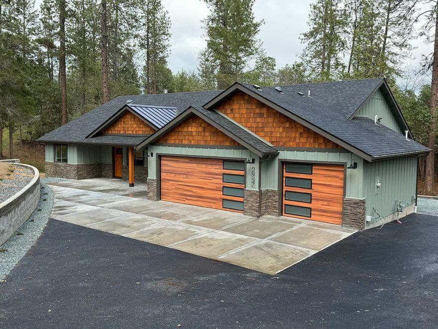 Brand new home on a private street, set on over two acres of peaceful seclusion, yet only a mile from shopping and the medical center. Surrounded by serenity, this home features hardwood and tile floors, cedar accents, and tongue-and-groove with exposed beam ceilings. The spacious kitchen is perfect for entertaining, and the dramatic floor-to-ceiling stone fireplace anchors the living area. High-efficiency gas heat and water heater add comfort and value. With countless upgrades and custom details throughout, this rare retreat combines privacy, quality, and convenience in one perfect package.