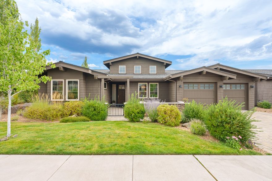 Discover exceptional living in Tetherow, where breathtaking mountain views and luxurious finishes come together seamlessly. Upon entry, you'll be greeted by soaring ceilings and an open-concept design, highlighted by expansive windows that frame views of the snow-capped peaks and the renowned Tetherow Golf Course. The main level features a spacious living area with three elegant suites and an office/den. The lower level offers two additional bedrooms, bathrooms, and a cozy family room. The chef's kitchen is a true standout, complete with Thermador appliances, a walk-in pantry, and a large island topped with granite countertops. Sliding doors in the great room and dining area open to a covered corner deck with a built-in fireplace—an ideal space to unwind while watching the sunset over the Cascades. A flawless blend of sophistication and comfort, this home will leave a lasting impression.