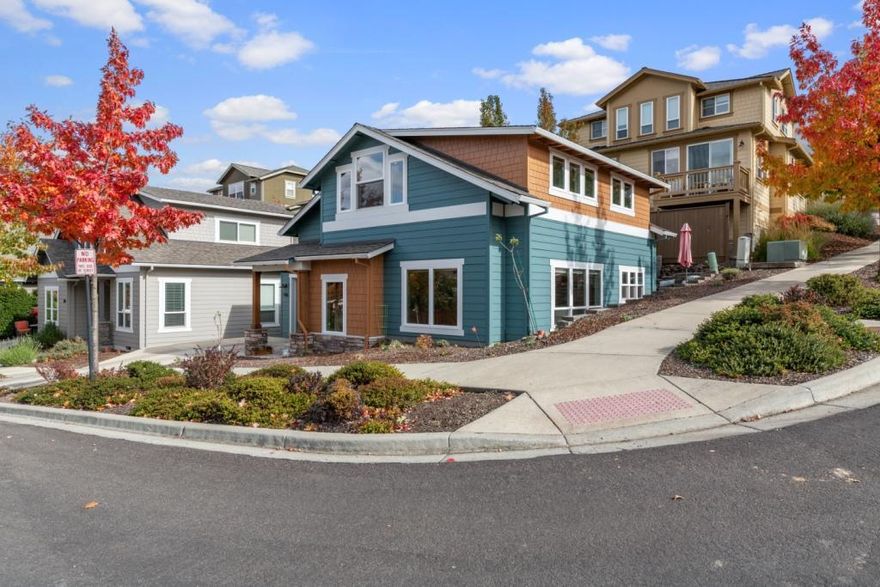 This is a wonderful corner lot facing south and west which allows this home to have an abundance of windows and natural light. There is direct access into the home and kitchen from the driveway or garage. . No need to carry your groceries up the stairs. Views of  Mt. Ashland and the surrounding mountains are fabulous and the trees, when they turn colors, in the fall are beyond spectacular. Open concept floor plan with the living room flowing into the dining area and kitchen. Living room has walls of windows looking out to the mountains and the valley. The kitchen has beautiful quartz countertops, walnut custom cabinets ,stainless steels appliances, a breakfast bar, and a door leading out to the sweet sunny deck. There is a bedroom on the main level with an ensuite bathroom and great closet space. Upstairs is the primary bedroom with an ensuite bathroom which has  a jetted tub/shower with custom tile work., There is an open office/den area next to the primary bedroom with views.