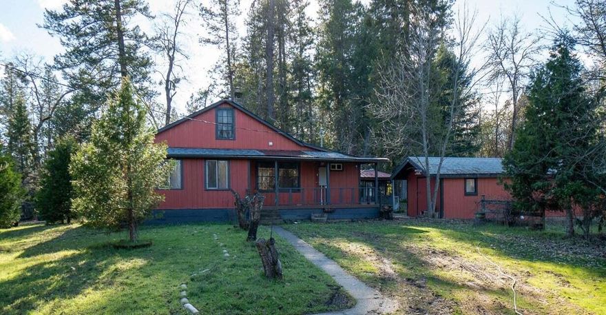 Set amidst the peaceful Williams Valley, this delightful property offers a serene country lifestyle. The cozy 2 bedroom, 2 bathroom home features a charming loft, a spacious living room with laminate floors, vaulted ceilings, and ample natural light. The country kitchen boasts abundant storage. With one bedroom upstairs and one downstairs, privacy is ensured. A bonus room downstairs would be a perfect office or could be used as a 3rd bedroom. The fully fenced yard allows for gardening, animals, and RV parking, complemented by a barn, separate storage/shop and a 2-car garage with a shop. While a previous hardship dwelling was removed, the connections still exist for potential development. Inquire with LA for high-speed internet options. Just 5 minutes to the local store and 15 to the grocery store.