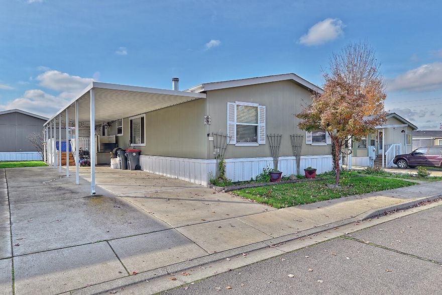 Experience the charm of this all-ages manufactured home in San George Estates Park, immersed in an array of fantastic park amenities. Step onto the welcoming covered front porch, relax in the living room featuring a cozy electric fireplace, and enjoy a kitchen with ample cupboard space and an adjoining dining area. Find solace in the primary bedroom with its private bathroom, along with two additional bedrooms, a full bath, and a laundry room with an exterior entry leading to the carport. Don't forget the convenience of a nicely sized storage shed. Enjoy numerous community amenities, including a rec room, playground, walking trail, and swimming pool. This home also offers easy access to nearby restaurants, wineries, and the Centennial Golf Club.