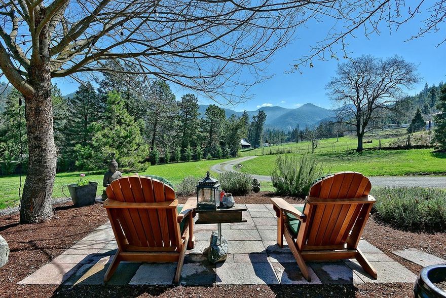 Gorgeous single level home in peaceful, private & serene setting. Tucked down a private drive on 2+ acres in the desirable Wagner Creek Valley, this beautifully built home is a true find. You will love the stunning great room with custom fireplace & built in bookcases, fabulous dining room & the heart of the home, the outstanding chef's kitchen. Perfect for entertaining the kitchen features huge island with dining bar, prep sink & new 5-burner Whirlpool range, granite counters, triple sink, & double wall ovens, Subzero stainless refrigerator & cherry finished cabinets. Split floor plan with large master with walk-in, luxurious bath with 2-person jetted tub & steam shower. Separate wing features the additional 3 bedrooms & 2 baths. 3 car garage & lots of RV space. Fenced garden area. Rear & front patios for relaxing & entertaining with sunny pastoral & mountain views. New floor heat boiler, heated floors throughout. Heat pump & AC fed by newer solar net system that ties into grid.