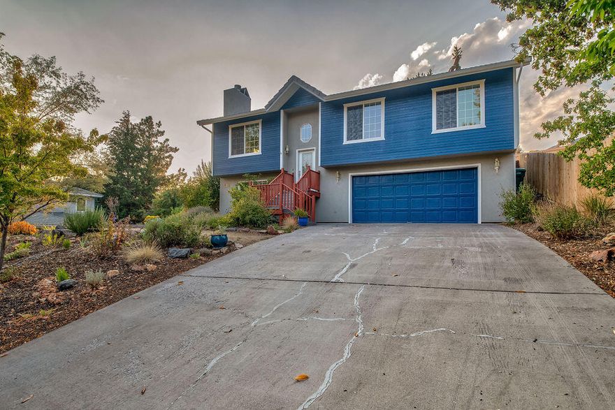 This spacious & beautifully presented home is nestled along a quiet street & is perfectly positioned to showcase views of Mt Shasta & the surrounding neighborhood. Depending on your needs, the floorplan can offer three bedrooms & two & 1/2 baths, plus an extra room that could work as a possible fourth bedroom or second living area. Tall ceilings & an abundance of natural light enhance the sense of space in the open-concept kitchen, dining & living zone with a gas fireplace for a cozy feel. The kitchen is a stylish haven with striking blue cabinetry, quality appliances and plenty of counter space for the cook.  Beautiful private deck & patio area with views over the yard while a hot tub is set just off the master bedroom. A drip system will keep the front yard looking lush while in-ground sprinklers have been installed in the picturesque & private backyard. This home's long list of features includes an attached two-car garage, ample closet space & laundry room. Exterior freshly painted