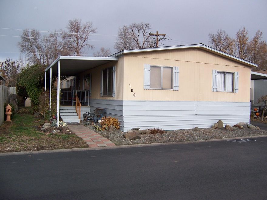 Nicely maintained 3 bedroom/2.0 bath home with open split floor plan located at the rear of the park with nice views. Formal living room, family room and dining room. Vaulted ceilings in the living room, dining room, kitchen and master bedroom. Home has some updates including newer counter tops in kitchen and bathroom, some newer light fixtures, and a new composition shingle roof in 2018. 1-Car carport and 2 storage sheds.