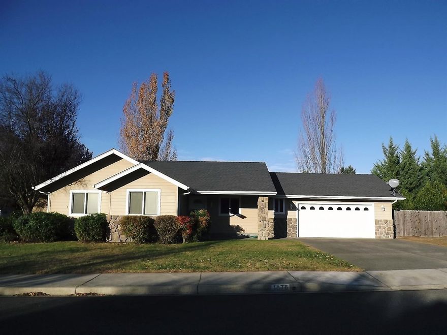 Location and Charm! This clean 3 bedroom, 2 bath home sits on a large corner lot with established lawn, fruit and shade trees, automatic in-ground sprinklers, and fenced back yard. Close to town, yet just a stone's throw from the beautiful Reinhart Volunteer Park with its many walking paths, ponds, and bridges. This move in ready home is on a quiet cul-de-sac in a lovely neighborhood. You'll love the vaulted ceilings, French doors off the dining area lead out to a covered patio, large laundry room with window and a wall of cabinets. The master suite boasts a large bathroom with soaking tub,stall shower, separate water closet and large walk-in closet. You'll love the 2 car finished garage & side yard that may accommodate a boat and/or RV. Come and view this lovely home today!