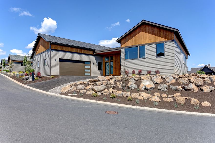 One of the last view lots in the coveted Trailhead neighborhood! This uniquely designed BendTrend home sits on an elevated corner  lot across from the Tetherow clubhouse and pool. A handful of entrance stairs lead to mainly single-level living in an open, vaulted floor plan boasting 3 generous bedrooms and an office.  The discerning quality and craftsmanship shine throughout the home with solid quartz surfaces, wood and tile floors, fully-tiled showers, custom closet packages, Jenn-Air Pro appliances, AC, Sonos system.  Enjoy taking in long-range mountain views from the walk-out deck, slip out your front door onto biking and hiking trails or enjoy a morning work-out class or evening dinner just across the street!