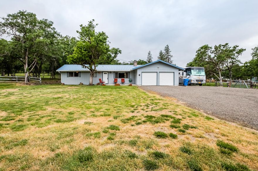This house is nestled at the end of a quiet road that features a flat pastured area that is fenced and cross fenced for your livestock or animals.  The oak trees provide shade for your summer activities and there's plenty of room for all your extra vehicles near the garage which has 2-30 AMP RV plugs, one beside the garage and the other around back.  The living/family room has rich warm hardwood floors that lead you to the dining room and kitchen, which features ample cabinetry, lots of counter space and a double sink.     The split floor plan has 3 bedrooms, 2 of which have been recently painted.  Enjoy the lovely views of the surrounding mountains and pastured grounds from all the windows throughout that bring in the natural light. 
A new HVAC system was installed in 2018 and the insulated pump house/shed has power.  This 1.5 plus acres feels like rural property, but yet, close to town!