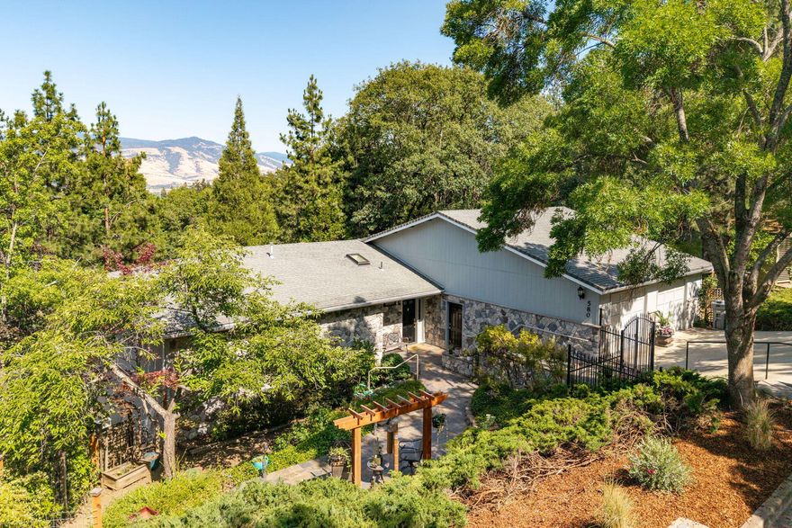 Beautiful 4BD/3BA, 3,022 sq ft home with a flexible layout perfect for dual living. The lower level has a private entrance, large living area, kitchenette, bedroom, and full bath—ideal for guests, in-laws, or a home office. Located in a quiet neighborhood near downtown Ashland and miles of scenic trails. Vaulted ceilings and picture windows fill the living room with natural light and showcase stunning mountain views. The updated kitchen includes stainless appliances and opens to an expansive deck for indoor-outdoor living. The main-level primary suite features deck access, a walk-in closet, and en-suite bath. Recent upgrades include new flooring, microwave, and water heater. Landscaped front and back yards offer tranquil gardens, raised beds, a Japanese maple, and TID irrigation. A peaceful oasis close to town!