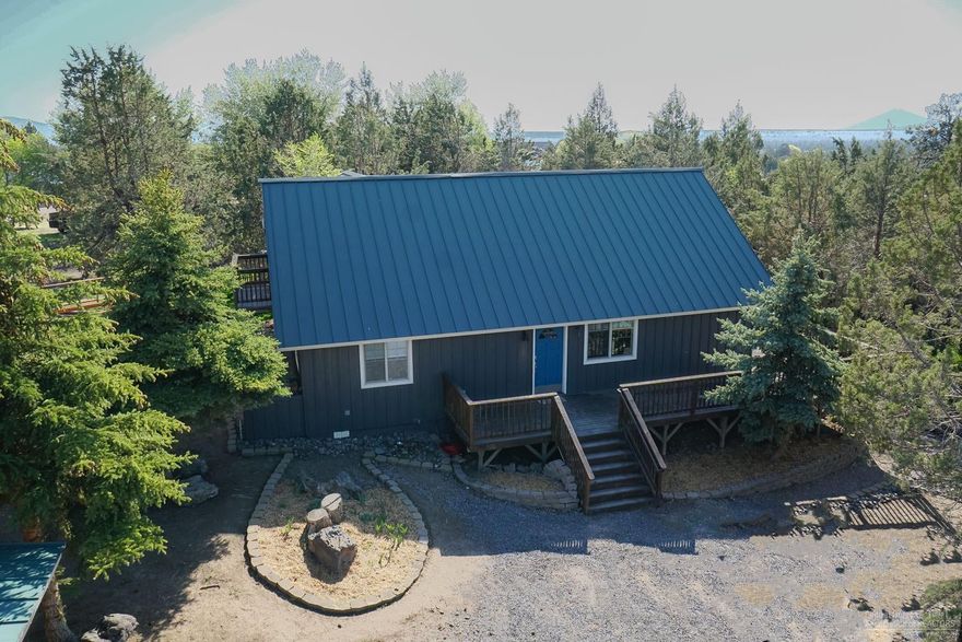 Acreage property minutes from Redmond! Nearly 5 fenced acres on a peaceful and private setting with sought-after irrigation rights. The incredible 3 bed, 2 bath home has been recently updated to include granite counters, new stainless appliances and tiled showers in the bathrooms. The open and bright great room is a perfect space for entertaining or relaxing with family. Enjoy fantastic views of Smith Rock and North Cascades. The detached garage/shop is heated and the equipment barn and shed provide numerous storage options. The wrap-around deck caps off this incredible home and property. The perfect place for a few animals or to spread out and relax!