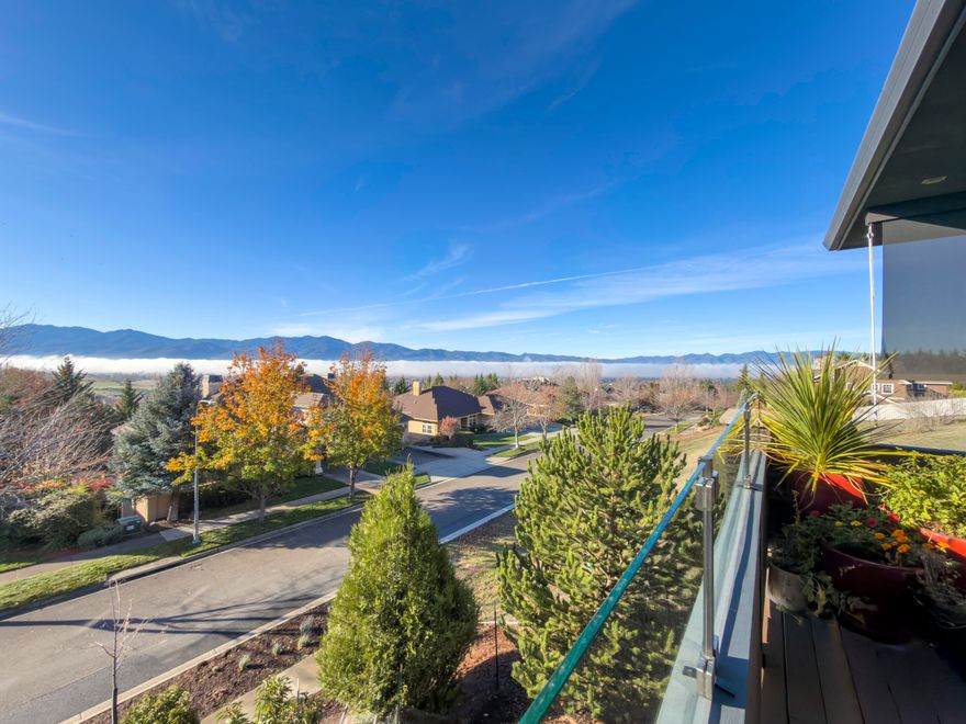 Architecturally striking and impeccably crafted, 280 Mary Bee Lane captures the essence of refined Northwest living. Designed by Ken Ogden and built by Michael Susi, this custom home is perfectly positioned to take in sweeping views of Mt. Ashland and the surrounding valley. Inside, rich Acacia hardwood floors, granite and marble surfaces, and extensive built-ins reflect a high level of finish and thoughtful detail. The main level features a spacious primary suite and subtle ADA features for long-term comfort. Outdoor living shines with a covered front deck, complete with a built-in kitchen and dining area, surrounded by beautifully selected native plantings. An oversized two-car garage, owned solar system, and optional two-family layout offer both flexibility and efficiency. A truly exceptional home in one of the area's most sought-after locations.