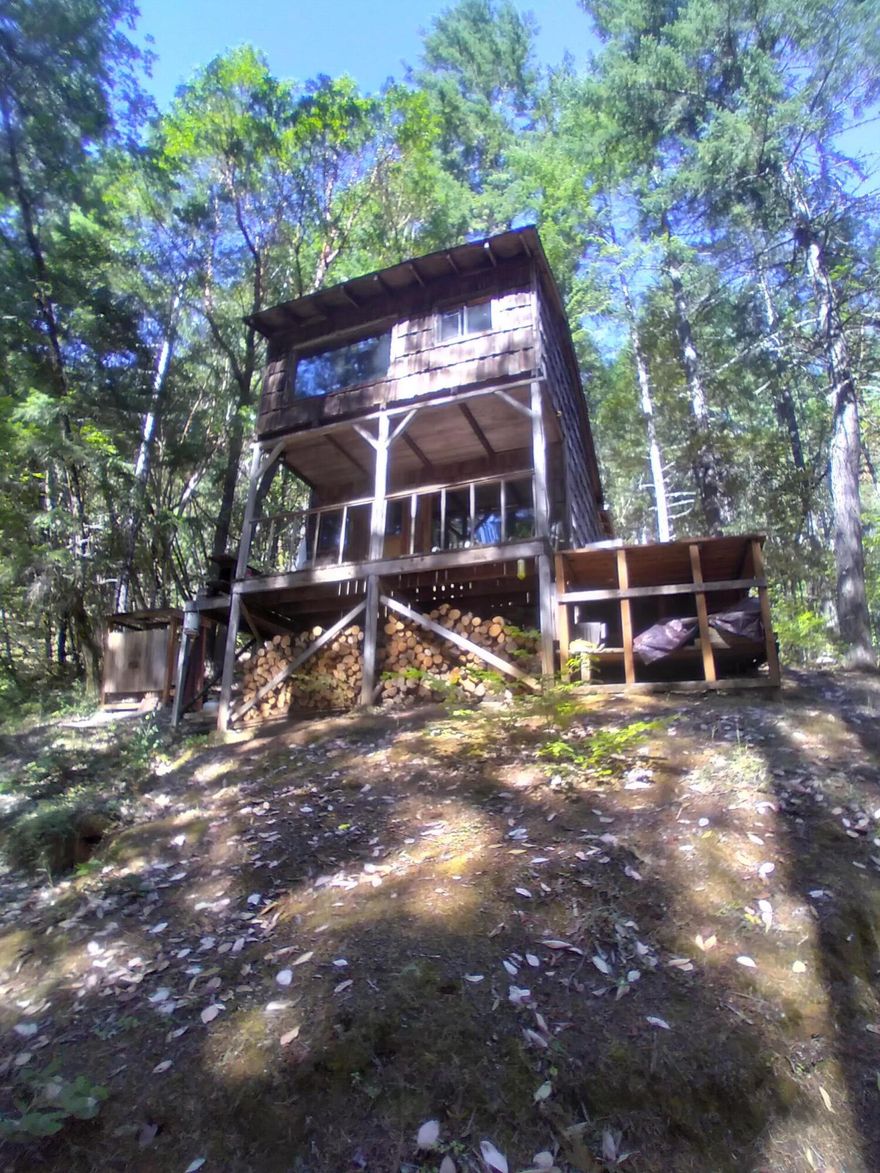 Great recreational property with 2 pre-existing older cabins on 40 remote acres all off the grid. There is a conservancy easement for environmental protection to maintain this setting. Very private and secluded with locked/gated entrance. Cash only purchase with verified funds.  Buyers to use due diligence.
