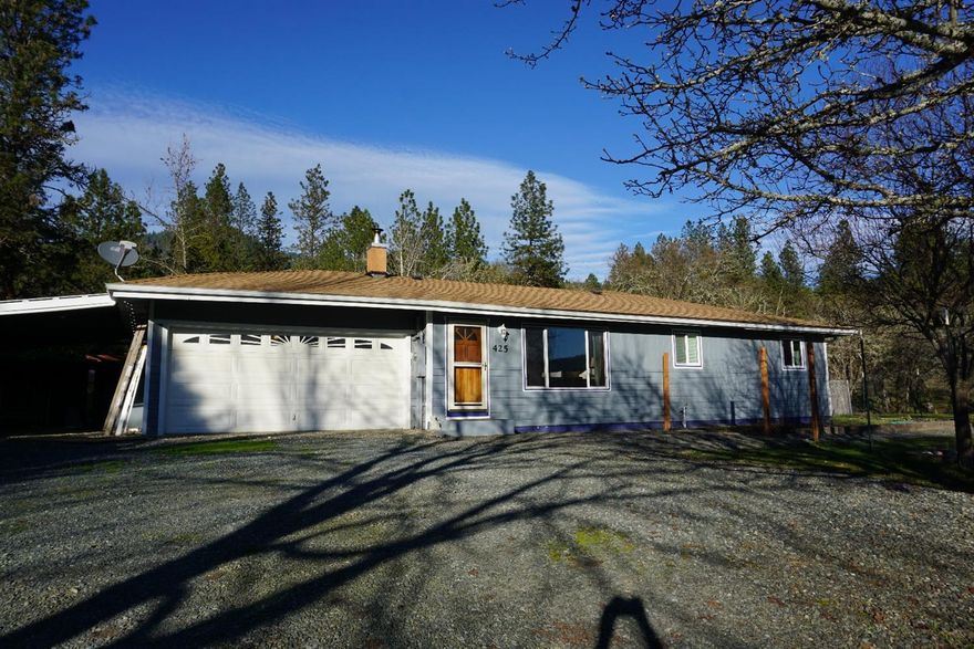 Just enough country living, but oh so close to all of the conveniences of the city. Set on a dead end road just outside of Grants Pass this 3 bedroom, 2 bath home sits on .98 of a treed acre. The home itself is spacious and open with a nice sized living room, a family room and a updated kitchen. 2 car garage plus carport. There is a heat pump for heating and woodstove in the living room. Large fenced garden area and a terraced rear private patio and yard. The shop is detached and very spacious! All information is deemed reliable but not verified; anyone considering purchasing this property should perform their own investigation into the uses and condition of the property.