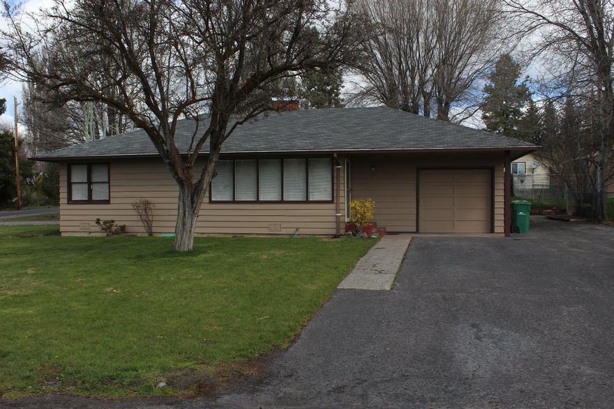 Cute 2 bedroom, one bath home on a large corner lot. Home has been updated with refinished original hardwood floors, new paint inside and out, and updated kitchen and bathroom. The gas fireplace gives this home a comfy feel. Covered patio and graveled RV parking in back.