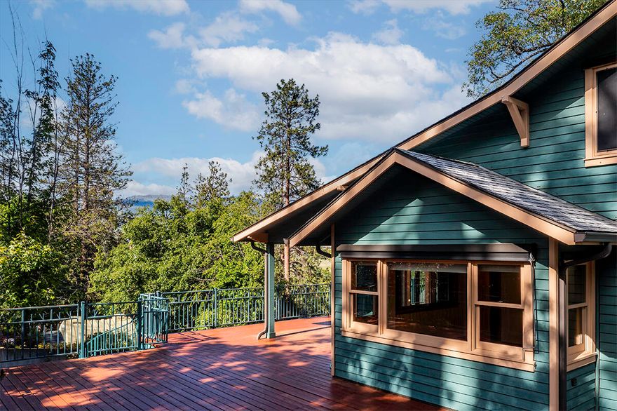 REDUCED-$195 SF! Private & double gated .63 acre parcel for this 4478 SF home with 6 bedrooms & 4 bathrooms. Entirely rebuilt in 1996 to combine modern luxury with timeless appeal & spacious living. Multiple distinct living areas cater to both relaxation & entertainment. The main living area has warm hardwood floors & an expansive, light-filled living room with stone fireplace. The chef's kitchen is the heart of the home with large island, 4-person dining bar, open breakfast & dining area & a separate office. Additional main living includes a versatile passive solar sunroom, dual bedrooms on the main level plus a 2nd office that could easily convert to primary bathroom. Upper-level features 2 bedrooms & a bath & lower-level features 2 bedrooms, bath & very large multi-purpose room.  Massive wraparound deck extends the living space outdoors & invites you to unwind & savor the remarkable setting. Detached garages, gardening beds, multiple sheds, lawn areas, blooms galore, privacy & view