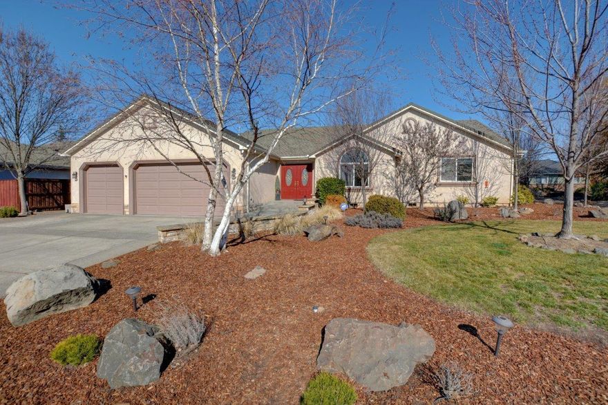 Come home to this move-in ready, lovingly maintained property conveniently located in the Eagle Point Golf Community.  Double door entry leads you into a bright & vaulted great room w/ceiling fan, see through gas fireplace & newer Pergo flooring throughout.  Kitchen w/all appliances included, quartz countertops, pendant & solar tub lights & spacious walk-in pantry.   Slider door off the dining room leads to a large covered patio w/skylights & fans perfect for outdoor entertaining.  Primary suite w/coffered ceiling, walk-in closet & slider to private & covered back patio w/hot tub hook up.  Two well sized bedrooms w/updated hardwood & bamboo floors.  Three car garage with 3rd bay converted into a flex space w/HVAC & perfect for shop, hobby room or guest quarters.  Situated on a .32 acre corner lot (only 1 neighbor), timed sprinklers, low maintenance landscape & backyard fully fenced w/water feature, koi pond, raised beds & garden shed.  Make this home yours before it's gone!