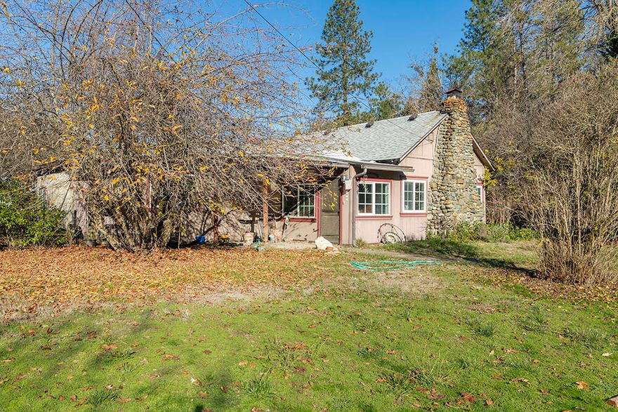 Quiet Rural Living can be enjoyed at this Perfect Mini-Farm Property, located just Minutes from Town! This Property Features a Cutesy Cottage-Style Home in a Desirable Country Setting!  The Single-Story 3 Bed 2.5 Bath Home offers 1644 sq. feet of Living Space, with a Huge Country Kitchen, Large Living Room with Woodstove, Covered Front & Back Porches, and Nice Multi-Purpose Room with Half-Bath, that could be utilized as an Additional Bedroom. Level and Useable .80 Acres Lot includes a Pasture Area for Animals, Large Barn, as well as a Covered Shed with Two Stalls. Barn could easily be enclosed to become a Great Workshop! Easy Drivable Access to the Pasture and Large Barn. This Home and Property are in a Fantastic Neighborhood of Similar Homes on just the right amount of Land! 10 min drive to Town, One Minute away from New Hope Christian School and 10 min from Hidden Valley High School. Minutes from Fish Hatchery Park, with Swimming Holes, Fishing, and Trails along the Applegate River!