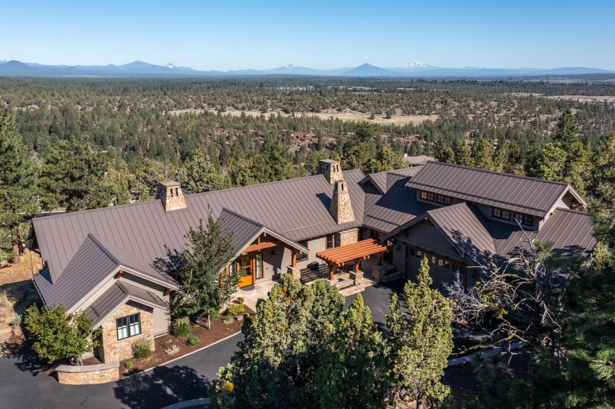 Majestic Cascade Mountain views from nearly every room of single level home in gated North Rim community.  Exquisite details are found throughout inc. antique pine heartwood flooring, Montana mossy rock, paneled ceilings, crown molding, designer tile & lighting. Great-room & dining, each w/ spectacular mountain views. Gourmet kitchen w/ top-of-the-line appliances, quartz, brushed stainless steel & heart pine countertops, Island/breakfast bar, butler's pantry w/ 2nd fridge/freezer, wine fridge & at the heart of the kitchen, a Mugnaini wood fired oven. Library hall, w/ bookshelves & window seats overlooking front courtyard, leads to owner's wing, w/ study warmed by cozy fireplace. Wake up to mountain views from serene bedroom suite & opulent bath. Guest wing w/ 2 lovely bedrooms, laundry & mud-room.  Bonus room is the ideal home office or in this case, a quilting retreat. The one-acre grounds & massive patio deliver the perfect venue to enjoy the peaceful setting & Cascade Mountain views