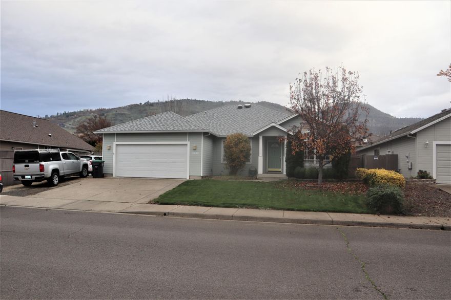 Beautiful East Medford home offers Formal Living Room & Rear Family Room with sliders leading out to the privacy-fenced yard & covered Patio - deluxe retractable Awning. Beautiful Ceramic Tile Flooring throughout Entry, Dining, Kitchen, Hallway, Baths & Laundry. This home is sporting a Newer Roof (2017) New Heating and AC Units (2018) and New In-Ground Sprinkler System both front and rear. Arched doorway leads to the Formal Living room w/Gas Fireplace. Formal Dining Room has vaulted ceiling & large windows to let in lots of light. Top of the line Plantation Shutters thru-out. Big Beautiful Kitchen with Corian Countertops, Under Cabinet lighting & Breakfast Bar with Pendant Lighting. All Appliances stay. Spacious Master Suite has coffered ceiling & Walk-In Closet. Adjoining Bath is very large & has double vanity, expansive mirrors, Vaulted Ceiling, Plant Shelf, Skylight with closable blind & oversize Shower. Attached Garage comes with lots of storage shelving. Small Gated RV Parking.