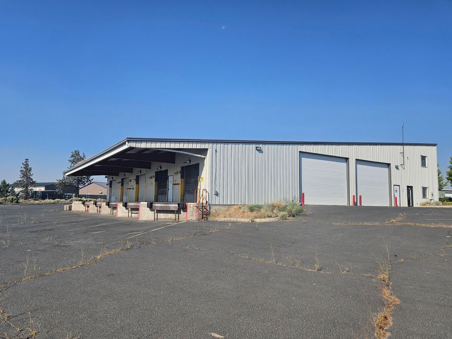 This 9,850 SF Industrial Building in Redmond is a great Owner/User or Investment property. The adjoining lot (.43 Ac.) at 2156 SW 2nd (Map and TL 151321AD01700) is included in this sale creating a total area of 1.42 total acres. The building was originally built for Roadrunner Courier/Express and later occupied by Diamond line trucking, features 5 dock-high loading doors as well as 2, 20' high roll-up drive through doors on both the North and South side of the building for easy delivery and shipping. The large warehouse area is open and is complemented by a reception area, 3 private offices, a break room and restroom. The roll-up doors have been either serviced or replaced. There is also a large second floor area over the offices with nice views for meetings or additional storage.