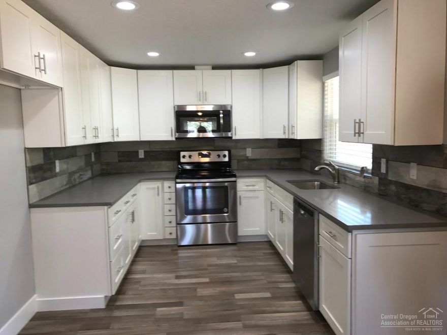 Modern cabin colors wonderfully updated home in Deschutes River Woods. New stainless appliances, spacious master suite with additional sitting area and second closet . Guest Bedroom is spacious with sitting area, and an additional bonus room would make a great office/den. Easy access on paved road beautiful filtered mountain views from front, Spacious laundry room with half bath off bonus room. 25x25 Shop/ Garage with oversized door. Extra large lot .87 acre. Endless possibilities.