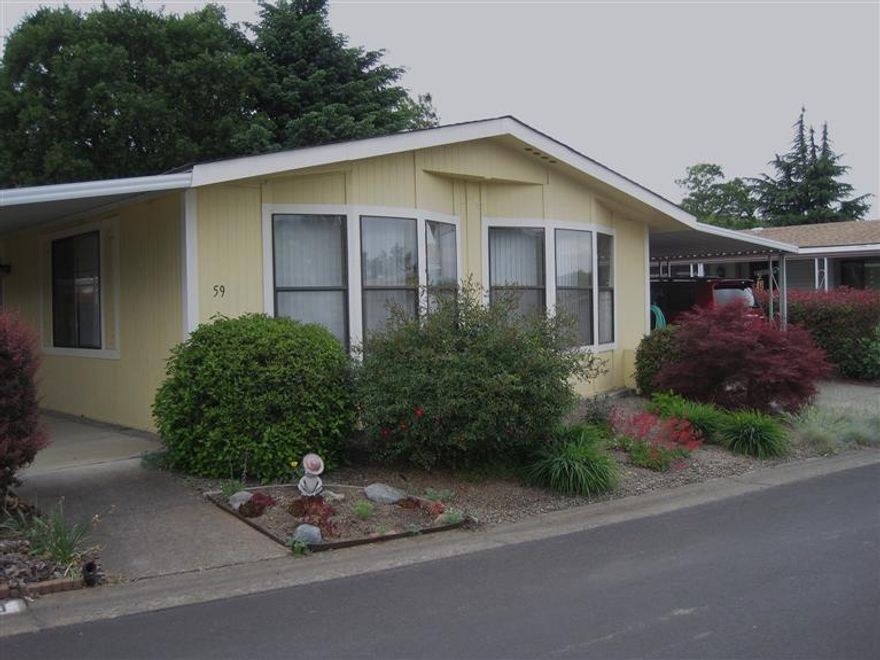 E-Z Care Contemporary! Here is a sunny 3 bedroom 2 bath home in popular Mt View Estates, a 55+ park in Talent complete with pool and clubhouse. Located on the outer ring of homes in the park, this home features include laminate floors in the kitchen, dining area and hallway. An open floor plan with lots of windows and vaulted ceilings give a comfortable feeling of space. Sliding doors in the master bedroom lead to the private back yard with no neighbors behind. A skylight in the master bath adds cheer. The roof was replaced in 2003 and the heat pump about 5 years ago. A covered front porch, double car carport, a storage shed with front and back doors complete the picture. From the outside painted a cheery yellow to the light filled rooms, it's Sun-Sational!