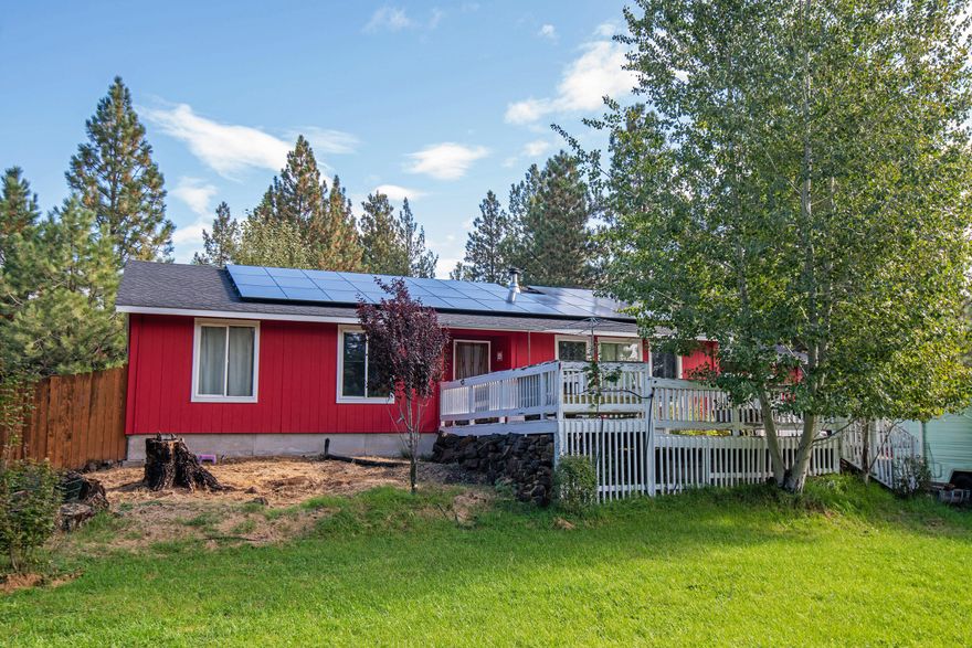 Unique one level home on large .55 acre fenced lot located on a private paved cul-d-sac.   Nice open floor plan.  3 outbuildings, all with power.  Private well.  Large covered private rear deck.  Large pond with fish, including koi, that runs year round. Pump included. Small soaking pool. Hot tub located in small enclosed outbuilding. Treed lot.  Landscaping includes many fruit trees and decorative plantings including honeysuckle, Asian lillies. Oversized two car garage with lots of built in storage.  3 bedrooms plus office. 220 power with back-up generator. 35 solar panels with 20 year warranty, supply enough power to make the electric usage $0 per month, very economical.