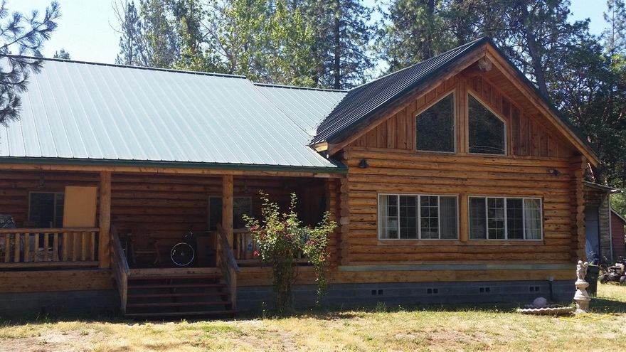 A Little Slice of Heaven Here on Almost 1 Acre with 2 gorgeous seasonal creeks running through! This fantastic true Log Cabin' Home has all log walls on a perimeter foundation with Doug Fir Ridge poles and Hard-Pine walls. The soaring vaulted ceilings and huge windows make the 2200 sq. ft. feel even bigger. Plenty of space here, with 3 big bedrooms, and great efficiency from the Geothermal furnace with electro-static filter. Built twice (in factory and on site), you enter the large living room through a 300-lb. front door. There's an abundance of tile throughout this gem, and a large indoor utility room. Cool and inviting covered porches make entertaining easy, and the Sellers state a great well with 1500-gallon reserve tank & 260-gallon pressure tank, and a newer hot water heater, too! There's a large shop & storage building for all your needs on some great usable land. This fantastic property is in a perfect location, just off of Old Stage Road. Bring your Buyers today!