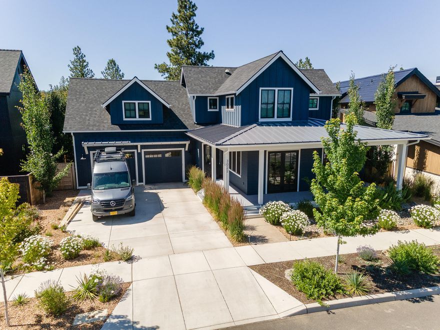 This stunning modern farmhouse is situated in one of Bend's most sought after neighborhoods, Discovery West. This home is situated on a spacious third of an acre lot, looking out to mature trees and an unbuildable green space, providing both beauty and privacy. The main floor features a primary bedroom and a generous office space. Upstairs, there are three bedrooms, a large bonus room with a full bathroom, providing plenty of space for family and guests. The gourmet chef's kitchen is a dream with top-of-the-line stainless steel appliances, a walk-in pantry, and a 4 ft. galley sink with interchangeable features such as cutting boards and a drying rack. The 4-car tandem garage is complete with an elevated washing station for Fido and also includes a full-size glass-paned door that opens to the low maintenance backyard. This custom home boasts a state-of-the-art heating and cooling system, as well as radiant heated hardwood flooring throughout the 3506 sq. ft. home.