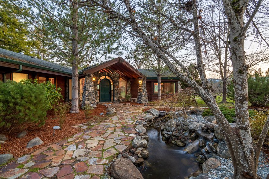 Welcome to Gunnell River Ranch! This picturesque property is a turn-key ranching opportunity on the banks of the Rogue River, which provides +/-70 acres of water rights. It includes a beautiful main home, an adorable guest cottage, large shop w/3-phase power, cattle barn, & a modern irrigation system w/center pivot - all on 94 acres! The expansive custom home is a captivating experience & features a stone fireplace, wood burning stove, entertainer's kitchen, open & airy living space w/windows overlooking the pastures below, a grand arched doorway, open beam vaulted ceilings, & more. The master suite is luxurious with vaulted ceilings, a 5-piece bathroom, & walk-in closet. A separate guest suite includes a full bathroom that also serves the living space. The sprawling acreage is both elegant & highly productive, offering 900' of riverfront, a paved driveway along an oak savannah, mostly class II soils, abundant recreation, natural beauty, & productive agricultural opportunities.