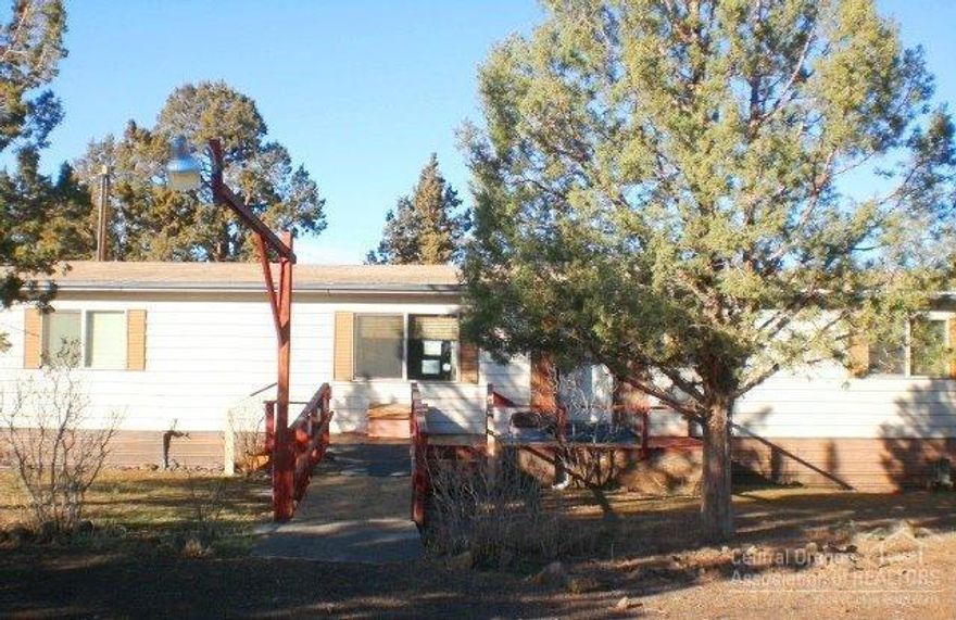 Hard to find country home on small acreage but close to redmond and Ridgeview High School. Plenty of room for all your toys! This three bedroom home has a large deck and several storage buildings too!