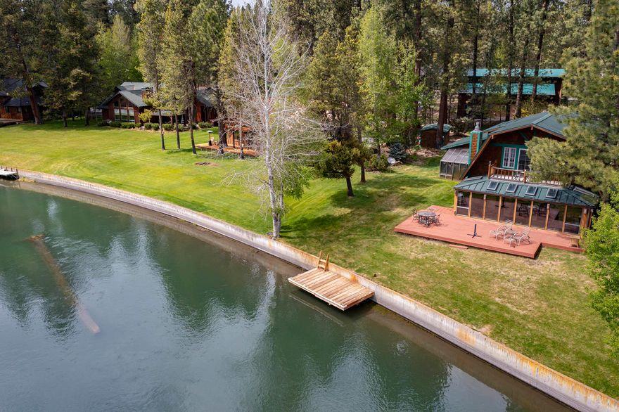 INCREDIBLE does not come close to describing this fantastic property on the Deschutes River and parcels like this one seldom come on the market.  The lot is 3/4 of an acre with river frontage featuring a concrete retaining wall and your own private boat dock.  The two story home features 3 bedrooms, an office, 3 bathrooms, a beautiful fireplace, a remodeled kitchen w/ great features including a 6 burner Dacor propane range and a sun room w/great views of the river and a split heat pump for those warm summer days. There are 5 ceiling fans located through out the home. One can enjoy watching the river go by while sitting on the deck which is only 18 feet from the river.  In addition to all of that there is a magnificent 2,900 sq. ft. 3 bay shop which is wired with 2- 40 amps, wired & plumbed for water & septic so you can charge your electric a cars and motor home. Upstairs is a finished room making for a great Man Cave or rec area. Furnished + $6,000 BBQ. Boat dock and retaining wall.