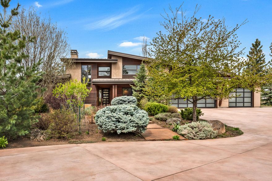 Cascade Mountain views steal the show on this private 1.42-acre westside property with no HOA. The home is surrounded by curated gardens and a glass greenhouse, with natural light pouring into every space. Step outside to direct access to Deschutes River trails, bike paths into town, and endless outdoor access just 18 minutes to Mt. Bachelor. Inside, the layout is warm and modern, with a rooftop deck, multiple fireplaces, and spacious indoor-outdoor living. The kitchen features a massive island, drawer fridges, and a professional-grade range. The main-level primary suite includes heated floors and direct outside access to a covered patio, while upstairs offers two bedrooms, a large view deck, and a second living space. The large pull through driveway leads to RV/Boat parking area and a huge light and bright oversized 3 car garage with ample storage. Every detail is designed to frame the landscape and feel connected to the surroundings.
