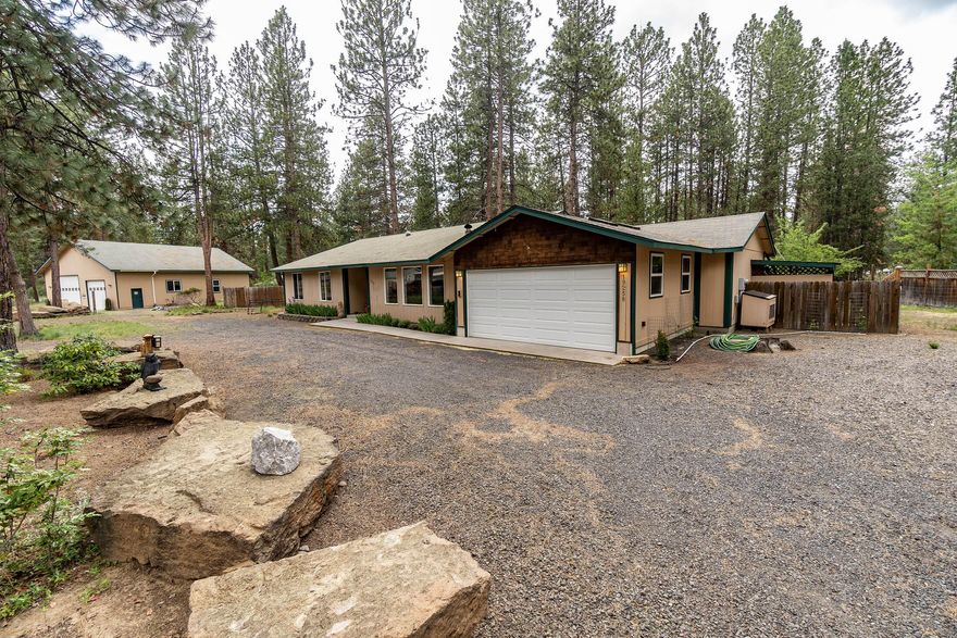 Nestled in the pines of DRW situated on a 1.4 acre lot is this 2188SF single story home complete with a 6 year old 2000SF (40'X50') RV sized shop.  The living room is quite spacious with a newer pellet stove, ceiling fan, open to dining room and overlooking front yard. Kitchen has new LG dishwasher, Samsung electric stove, eating area, gleaming hardwood floors, ceiling fan and overlooking the backyard.  Primary bedroom has walk-in closet and full bathroom.  Enjoy outdoor entertaining on your partially fenced yard with patio for a BBQ or your morning coffee.  And let's not forget about the fabulous RV-sized shop with is a great get-away for all your projects or to store all your toys.  This is a must to see!