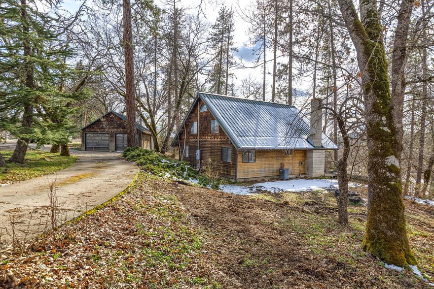 Adorable country living at it's finest! Situated on a dead-end country road, near the Rogue River sits this cute-as-a-button cedar sided modest home. The home itself features 3 bedroom, 2 bathroom, open living area with wood burning fireplace, great loft area upstairs, nice outdoor decking and great views of the surrounding properties. Also on the property is a detached 2 car garage and small storage barn. Lots of wildlife and semi private within a great neighborhood. Great rental history and a cool location make this one a must see!