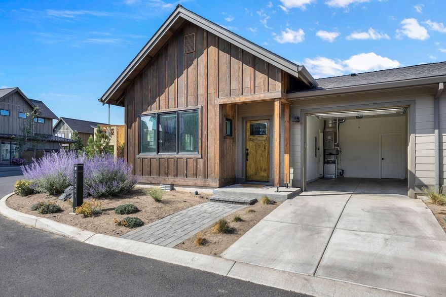 Here's the one you've been waiting for:  Located in the desirable Highlands Ridge at Tetherow, this single level townhome lives like a detached home, sharing only a garage wall. Inside, the home is filled with natural light, modern finishes and hardwood flooring. The gourmet kitchen has high-end appliances, sleek cabinets, and solid surface counters. A generous island with bar seating flows seamlessly into the dining area, ideal for entertaining. The living room offers comfort and style with its large windows and fireplace. The one-car garage includes additional storage and EV charger. Two spacious en-suite bedrooms provide comfortable retreats. Beyond your doorstep, you're steps from Tetherow Resort's pool and amenities, and a short drive to Mt Bachelor. Enjoy nearby hiking or bike on Phil's trail. This home offers the perfect blend of luxury, comfort, and convenience, making it an ideal place to call home in Bend.