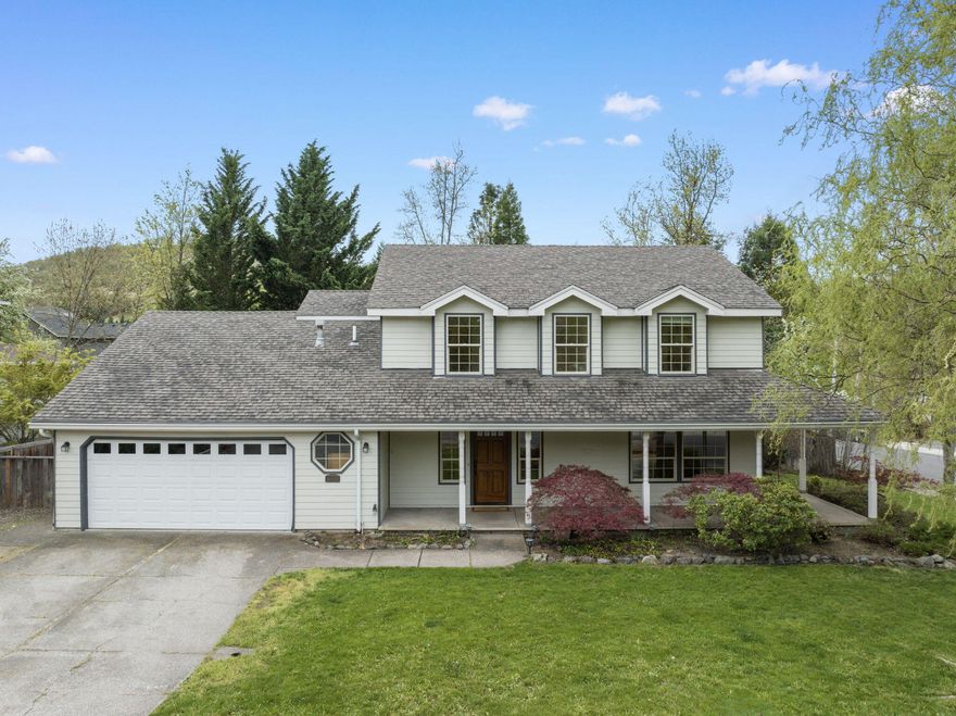 Four bedrooms including a main-level bonus suite means you'll have room for everyone in this lovely Eagle Trace home. The bonus suite has an attached full bath and French doors to the kitchen/family area. Use it as an in-law suite, home office, home school space or game room! This home also boasts one of the largest lots in this quiet and desirable neighborhood. With a fenced and nearly level private back yard, you'll have plenty of space for gardening, play or just enjoying your private retreat. Inside, the home is fresh and ready for you with newly refinished hardwood floors, new carpet, new dishwasher and fresh paint. Lots of windows let in sunlight; upstairs, they frame views of Roxy Ann Peak. The large kitchen features a functional island, spacious pantry and terrific workflow. It opens onto a formal dining room, eating area and family room. Sliding doors to the back yard make indoor/outdoor living a breeze.  Make it yours today!
