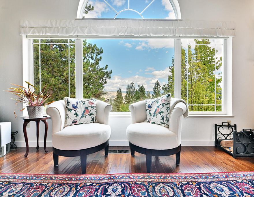 Peace, Beauty • Rogue Valley Views • Trailheads. In Town. Fall in love with this Upper Diamond neighborhood home of luminous spaces and serene views. Formal dining area with cabinets. Great room and MBR peaked ceilings. Sunroom for casual dining, games. Irrigation system, fireplace In town with full services, only a minute away from the woods! This 2332sf home mirrors the tranquility of its wooded surroundings— its vistas across the Rogue Valley will leave you and your guests' beauty-struck and smiling. Sunlight floods the interior, Acacia wood floors add luxe and warmth. The MBR suite is spacious with scenic views. Two BDRMS face west: 1 carpeted, 1 office w/ skylight. The 2+car garage includes storage. The backyard has a large deck, and the mountainside above holds only Siskiyou Mtn Park trails and Ashland watershed land. It's uphill between SOU and downtown, within minutes of everything ''Ashland''; only 30 mins. to Mt. Ashland for winter skiing and summer outdoor fun.