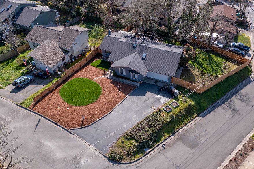 GEM on the north east side of Grants Pass! This stunning 3 bedroom, 2 bathroom home has undergone extensive preventative maintenance & updating, ensuring a hassle-free living experience. The property boasts a new roof and gutters (2022), adding durability & peace of mind. Step outside onto the gorgeous, brand new,  multi-level deck, perfect for entertaining or enjoying the serene surroundings. Inside, you'll find new flooring throughout, creating a fresh & modern ambiance. The kitchen is equipped with updated appliances, the living room is bright and open with a bonus sunroom you can enjoy all year! The bathrooms have been beautifully updated, providing a spa-like retreat. Additionally, the property features fresh new landscaping, new fencing, offering privacy and security. With all the hard work already taken care of, this beautiful house is ready for you to move in and make it your home. Don't wait, don't hesitate, call to see this gem today!