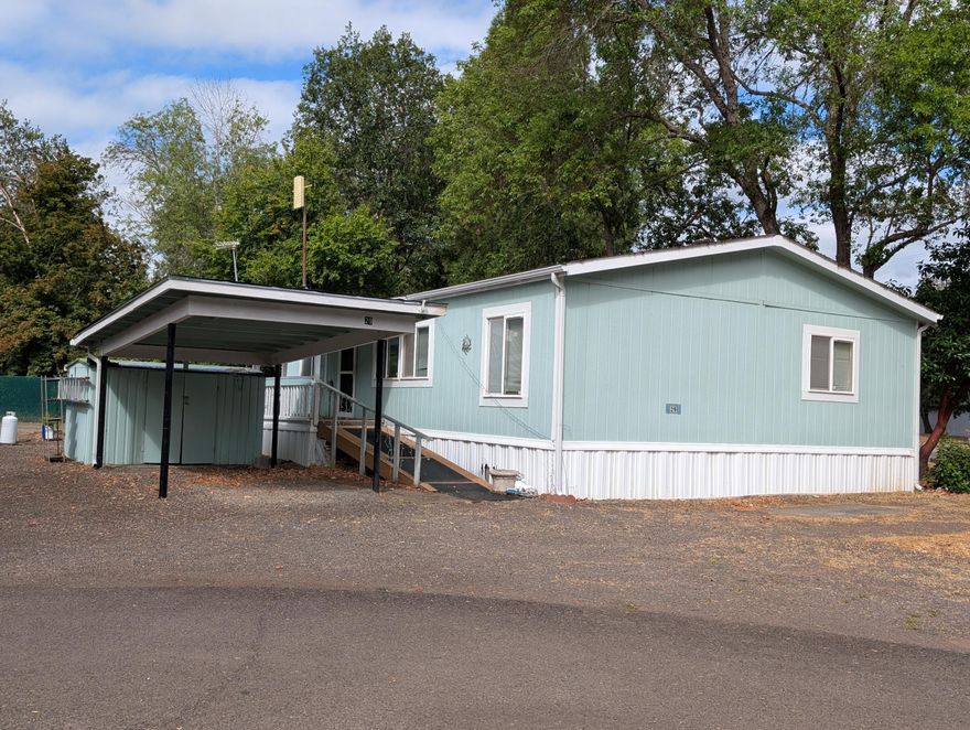 One of the few double wide manufactured homes in the community. Comes with a carport. This home has three bedrooms and two full bathrooms. Open kitchen with plenty of cabinets and counter space. Spacious laundry room. The home is a split floor plan with primary on one side of the home. Natural light flows within. Needs a little TLC and carpeting however the price reflects this. Don't let this one get away. This is a 55+ park