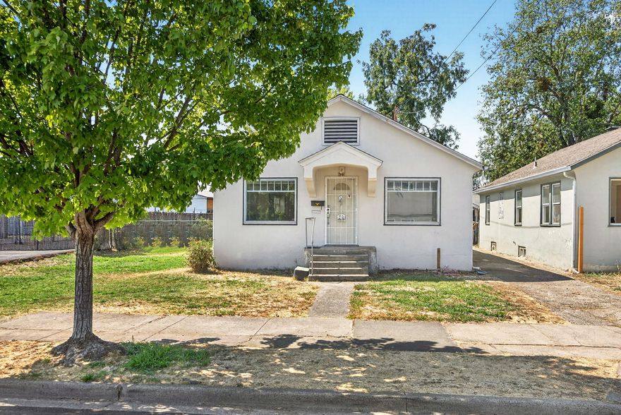 Wonderful West Medford Opportunity! This charming 1920's fixer-upper offers timeless character and solid bones, ready for your vision! Featuring 1,040 sq. ft. with 3 bedrooms and 1 bath, the home has beautiful oak floors and plenty of potential. A spacious walk-up attic could be converted into additional living space, while the full basement provides ample room for laundry and storage.Set on an oversized .27-acre fenced lot with mature shade trees and a storage shed, the property also offers development possibilities; up to three additional units may be allowed (buyer to perform due diligence with the City of Medford). With just a little TLC, this home will shine, as a personal residence or an investment property. Quiet neighborhood near shopping, restaurants, and parks.