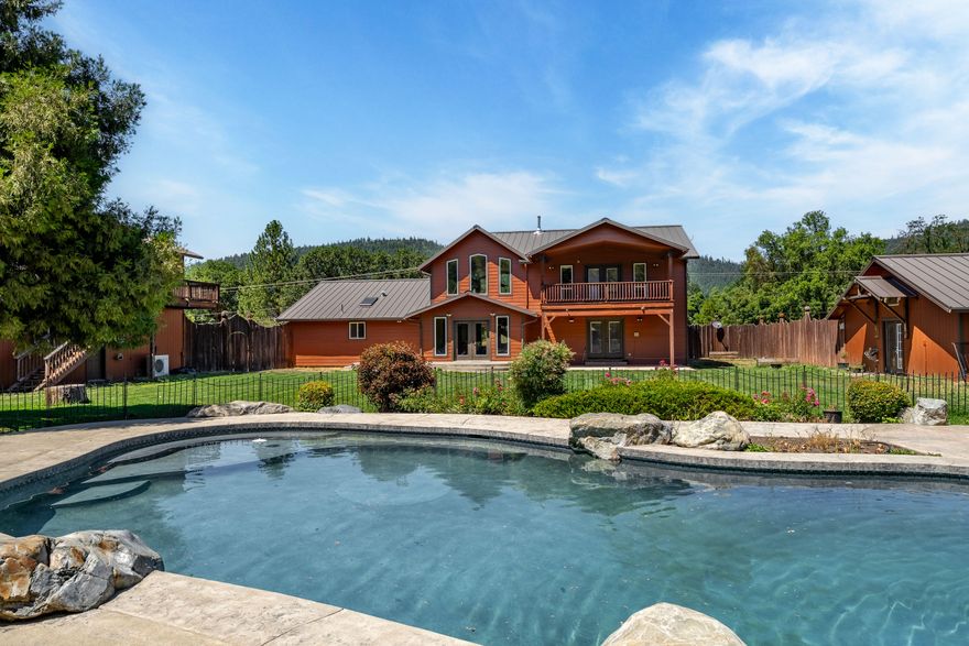 Experience privacy, space, and versatility in Southern Oregon's scenic Illinois Valley. Set on 4+ acres near Lake Selmac, this well-maintained home features four bedrooms, a large primary suite, three baths, and a chef's kitchen with double oven, granite counters, and a 6-burner Viking cooktop. Entertain or relax outdoors with a saltwater pool, outdoor kitchen, and bath. Multiple finished shops, a detached guest apartment, 25x25 bonus room, metal roof, and 400-amp service add flexibility for hobbies, business, or multi-gen living. Zoned HVAC, backyard landscaping, and wiring for a whole-home generator complete the package. Located 30 minutes from Cave Junction, 45-60 minutes to Grants Pass, and 90 minutes to the Oregon Coast, this move-in-ready property is perfect for those seeking a rural lifestyle in Southern Oregon. Homes with this amenity package and acreage rarely hit the market—schedule your private tour today before this unique opportunity disappears.