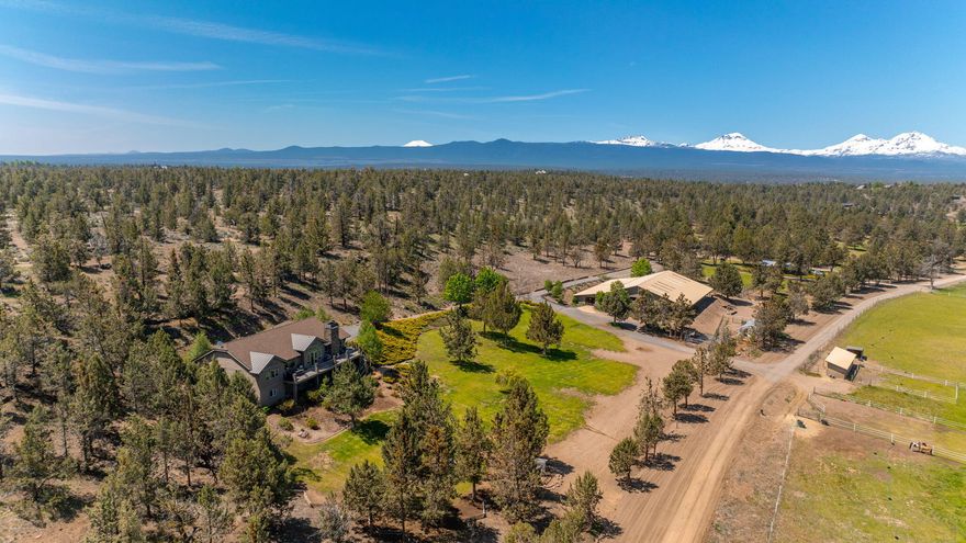 MK Ranch is the definition of Tumalo tranquility with nearly 60 acres of privacy for the equine and ranch enthusiast. Expansive views from the Cascades to the Ochocos & the wonder of the regular wildlife this property is truly a gem of Central Oregon. 2 legal parcels combine to create one expansive property. The main house at 3700 SF on the ridge overlooks the valley, pastures & hay field. Nestled on the lower parcel is a second 1863 SF home, where the successful short & long-term rental history coupled with barn stall rentals, provides income potential. 14 stall barn w/ sprinklered indoor & outdoor arenas. 45 acres of irrigation keeps the pastures & hay field lush. 1650 SF shop. The orchard  & 20' x 30' greenhouse are perfect for the gardener. Rarely does a property like this come along, where the sunlight rises to greet you with incredible eastern views & shines from the Cascades to create a peaceful, country life dreams are made of.