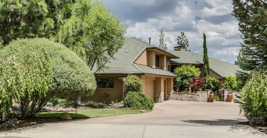 Elegant Awbrey Butte residence, light & bright with expansive NE Mountain & City Views. A large flat driveway off a quiet cul-de-sac & tile roof are stand out features for the Awbrey Butte neighborhood. Expansive Northerly, Cascade Mountain, Smith Rock and twinkling lights City views. Impressive Chef's kitchen with new Thermador SS Appliances, gas fired bread/pizza oven, double islands, tons of custom cabinetry, storage & a restaurant style pantry. With the Main level master suite & private office, this home lives like a one level with no stairs at the entry or from the garage. Upstairs are 2 bedrooms, full bath and a library loft. Downstairs is the Guest bedroom, a true theater room & the temperature controlled 3800+ bottle wine cellar. South facing indoor garden brings light & nature inside year round. Extensive outdoor living spaces with multiple stone patios & water features, beautifully landscaped & lighted- especially usable in the summer months with relief from the Western sun.