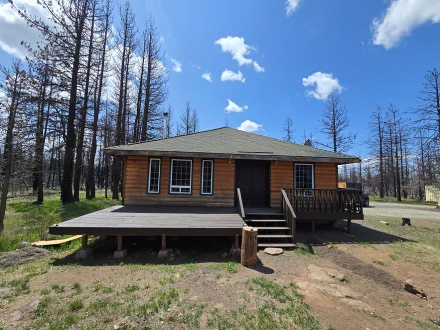 Escape the hustle and bustle of city life with this stunning off-grid log cabin, perfect for those seeking tranquility and independence. This charming 1-bedroom, 1-bathroom cabin offers 1,024 square feet of cozy living space featuring beautiful vaulted ceilings that enhance the open, airy feel.  Recently updated with new plumbing and a high-efficiency water heater.
Eco-Friendly Living: Equipped with a brand-new solar setup, allowing you to enjoy sustainable living without sacrificing modern comforts.