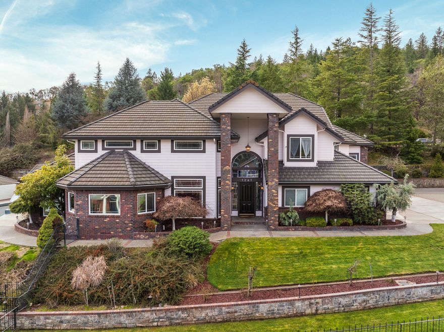 Discover luxury living in this 4,512sf gem on a .56-acre lot in one of Grants Pass' premier neighborhoods. This 4-bed, 4.5-bath home showcases a sprawling open living space, complemented by a chef's kitchen with 'SubZero' fridge, double ovens, & a gas cooktop on a grand island perfect for entertaining. As you step outside, envision summer days on the patio, feet in the pool, soaking in majestic views, or unwinding in the jacuzzi by the pool house. The main level hosts a home office w/ built-in cabinets, alongside a master suite w/ stunning ensuite bath. Venture upstairs to discover 2 guest rooms, 2 baths, & a generous bonus room. Additional perks include a laundry room, garden area, & an oversized 3-car garage plus an attached RV garage/recreation area. Not to be forgotten is the detached pull-through RV garage w/ a spacious bonus room upstairs. All conveniently located minutes from shopping, restaurants, District 7 schools, parks, & Interstate 5. Are you ready to make this your home?