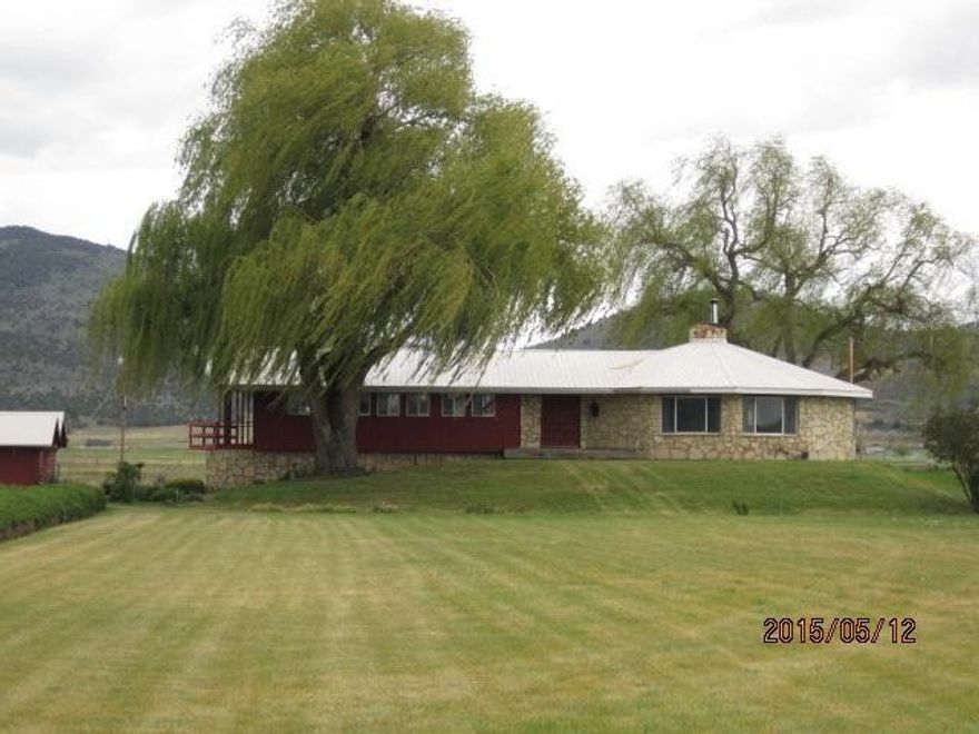 Where To Begin, This Property Is A Must See With So Much To Offer! It Is The Ultimate Setting, Bordering The Lost River And Surrounded By Blm Marshes. For Those Waterfowl Hunters Out There, Who Wouldn't Want Hunting Access Out The Back Yard? Not To Mention It Is Almost 4 Acres With A Fenced Pasture, Garden Area, Barn , And Additional Outbuildings For Extra Storage Or Workshop Space. The Property Has In-ground Sprinklers, Both Front And Back, That Use The Lost River For Irrigating. A Variety Of MatureTrees, Including Fruit Trees, Provide Shade As Well As Privacy From The Roadway. The 2200sf Home Is Very Custom With A Wrap Around Floor Plan And Large, Floor To Ceiling Windows To Enjoy The View From Every Angle Of The Home. The Living Room Is Huge With A Custom Built Bar, Which Merges Into Formal Dining With A Stone Fireplace To Set The Mood. Enjoy The Sunset Reflected Colors Over The Fields While You Prepare Dinner In The Rustic Kitchen With Original Cabinets, A New Ge Stove Top, Marble