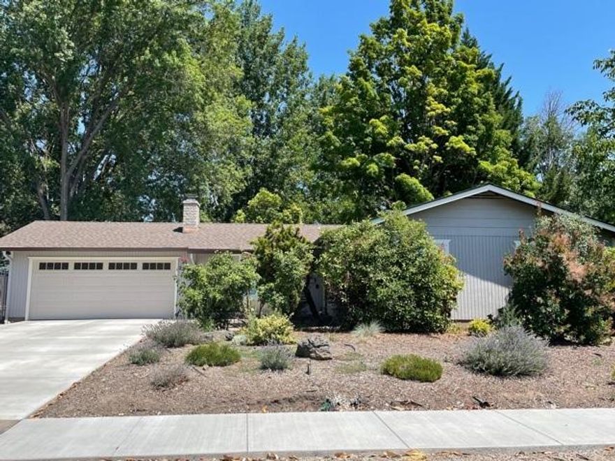 Charm and location, location, location! Steps to medical, schools and shopping, this single level home on a large .21 landscaped yard has newer heating, roof, garage door, gutters, windows, sprinklers and driveway! Very livable floorplan features a real fireplace and vaulted, wood beamed ceilings; breakfast nook and a park-like back yard! Very nice!