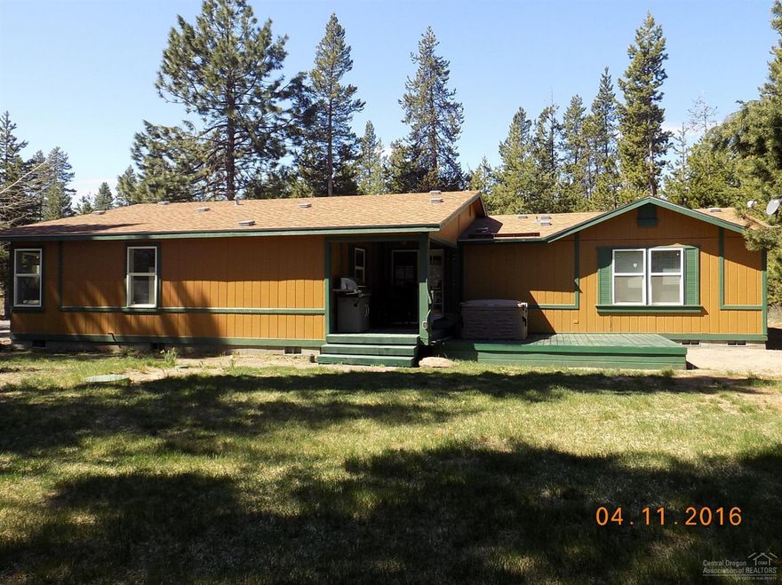 Wonderfully maintained home on extra large 1.13 acre corner parcel. Just a few lots in off paved Pine Forest Rd. Triple-wide home with Detached 2-car garage. Nice covered rear deck for afternoon/evening use. 1-year old Hot Tub/Spa for relaxing. Open, flowing floor plan with good separation of master from the other 3 bedrooms. Open Kitchen with large dining area and spacious vaulted living room. Vaulted master suite with walk-in closet. Plenty of space and elbow room here! New laminate flooring.