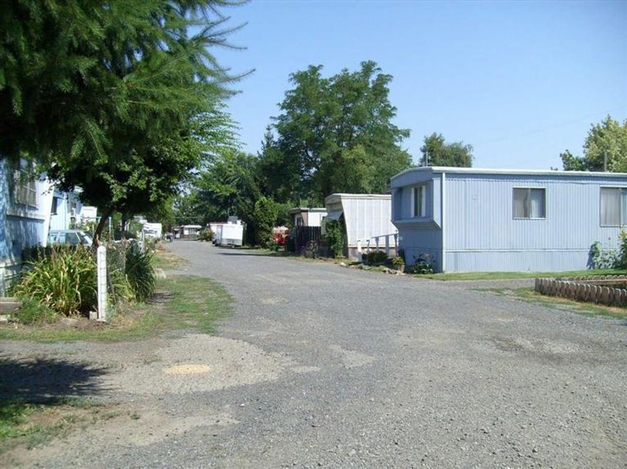 52 space mobile home park in a great neighborhood in Central Point. Surrounded by newer subdivisions. Also includes a house and 3 RV spaces. 3 of the spaces are empty. Space rent including the RV spaces are $350.00 a month, house rents for $850.00, and manager gets free space rent. Most of the tenants have singlewide mobiles. Park needs very pro-active management or possible upgrade. Lots of upside potential. Great income producer. Call for financial information. All information deemed reliable but not verified, anyone interested in the purchase of this property should perform their own investigation into the use and condition of property.